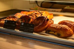 A display case filled with lots of pastries